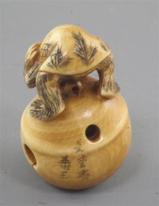 A Japanese ivory netsuke, carved with a monkey crouching on a bell, late 19th/early 20th century 4.3cm